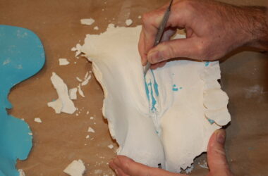 picking alginate residue from a plaster vulva cast